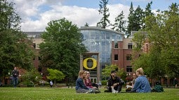 Students talking on the lawn.