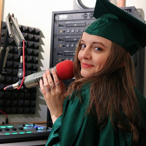 sophie cenitta in KWVA radio booth with grad cap