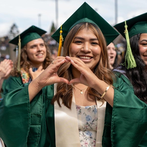 student making O hand gesture at commencement